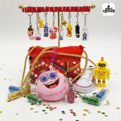 Navratri Hamper Collection of colorful keychains, pouches, and toys on a white background with confetti.